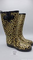 Side view of the tall leopard print rainboots with black adjustable buckle and glossy finish.
