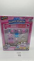 Shopkins Happy Places Sunny Laundry home collection set in original sealed packaging with pink box and clear window showing mini laundry-themed figures and accessories.
