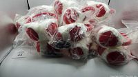Lot of 23 Tim Hortons branded headphone earmuffs stacked and individually bagged in some cases