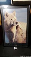 Full view of framed wolf picture showing two wolves nuzzling with Brandenburg label.