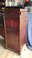 Front view of oak cabinet phonograph with closed lid
