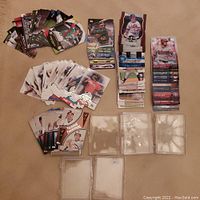 Loose piles of Topps baseball cards from 2013-2015 arranged on floor with 6 clear plastic containers for storage, one cracked