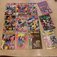 Top view of 12 Guy Gardner related DC Comics laid out on carpet floor, showing colorful illustrated covers.