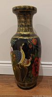 Front view of vintage ceramic floor vase featuring a peacock and red floral hand-painted design with gold crackle neck and base.