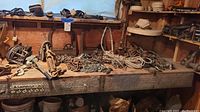 Workbench surface showing piles of chains, hooks, springs and ropes