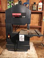 Full front view of the Craftsman 9-inch band saw showing the full machine, cutting band and work table.