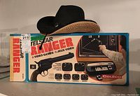 Vintage Telstar Ranger video game in original box with gun controller and black cowboy hat behind it