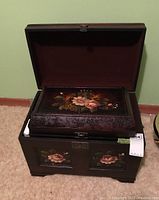 Photo of the largest chest open with the smallest chest placed inside it, showing the dark fabric interior.