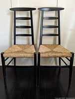 Front view of both chairs showing ladder-back frames and rush seats