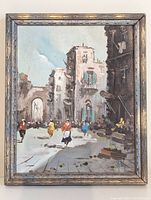 Frontal image of framed Italian streetscape painting showing city street, figures, and archway under daylight.