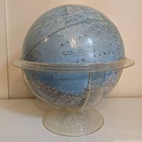 Full view of the vintage National Geographic globe on its transparent plastic stand, showing the southern hemisphere and part of the Pacific Ocean.