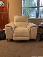 Front view of white leather power recliner chair in upright position