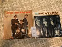 Photo of two Beatles vinyl record albums side by side titled Introducing The Beatles and Meet The Beatles.