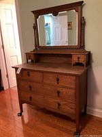 Front view of oak dresser showing four drawers and attached mirror