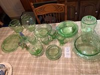 Overview of all green depression glass pieces on table