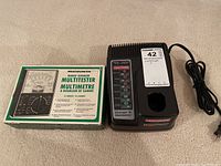 Craftsman charger & Micronta multitester with charger plugged in for display