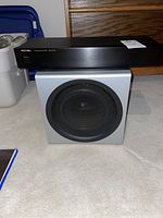 Rotel RQ-970BX phono equalizer on top of Logitech Z-2300 subwoofer showing front and speaker grille.