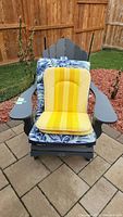 Full view of gray resin Adirondack lounge chair with both cushion types in place