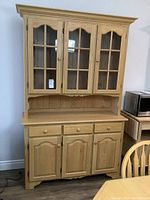 Full view of buffet hutch showing both upper glass door cabinet and lower wooden door storage with drawers
