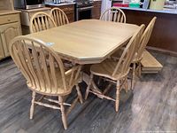 Full view of rectangular oak table with six chairs arranged around