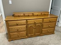 Frontal view of dresser showing overall design, drawers and finish