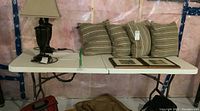 Full view of the foldable plastic table showing its surface, some items on top, and surrounding area.