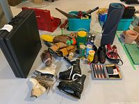 Overview of all sports and exercise items including exercise mat, yoga mat, figure skates, hockey skates and gloves, baseball gloves and bat, tennis balls, hand weights, and travel backgammon board.