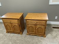 Front view of both nightstands side by side on carpeted floor