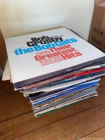 Stack of vintage vinyl record albums with 'Bob Crosby and his Orchestra the Bobcats Their Greatest Hits' album on top