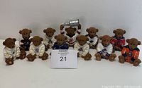 Full set of 11 ceramic teddy bears in various NHL hockey jerseys, including one holding a Stanley Cup trophy, all sitting on white background.
