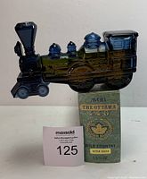 Front and side view of the green glass train-shaped bottle with original box, showing 'Avon The Ottawa 440 Wild Country After Shave' label with 5.5 fl oz volume.