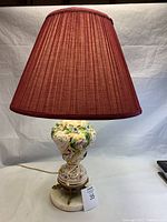 Full view of the porcelain lamp with lampshade, showing intricate hand-painted floral patterns on the body.