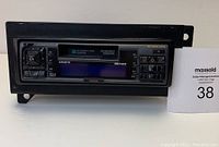Front view of Clarion ARX8170 car stereo showing full unit with removable front plate, button controls, and display screen.