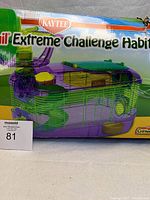 Front view of Kaytee CritterTrail Extreme Challenge Habitat box, showing the multi-level purple and green plastic cage designed for small animals like hamsters, mice, and gerbils.