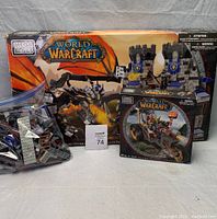 Three Mega Bloks World of Warcraft boxed sets plus loose building pieces in plastic bags.