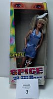 Front view of Baby Spice doll in original packaging box with visible damage