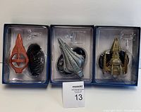 Three Star Trek Eaglemoss ship models in original blue display packaging showing the Hirogen Hunter, Voth City Ship, and DKyr ships with their display bases included.