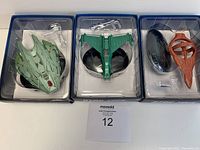 Three Star Trek model ships from EagleMoss in original packaging showing the Klingon Transport, Klingon Attack Ship, and DKyr ship with clear display stands.