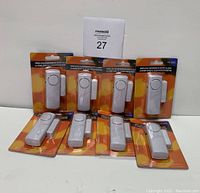 Eight wireless window/door entry alarms displayed in original packaging, front view showing product design and branding.