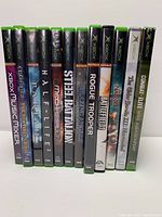 Front view of 12 Xbox game cases showing titles and Xbox branding