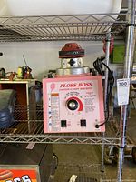 Full view of pink metal base and chrome spinner head on wire shelving