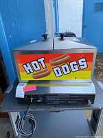 Front view showing “HOT DOGS” signage, two hinged lids and front panel.