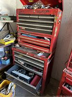 Photo of the red Craftsman toolbox containing various tools with some drawers open showing contents.