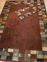 Photo of both rugs laid out on the floor showing the full pattern and size difference.