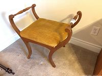 Full view of wood frame bench with gold velvet upholstery, showing overall shape and condition including curved legs and arms.