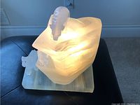 Photo of lit marble lamp showing the top bear figure and glowing marble surface