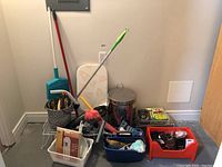 Overview of all items showing various cleaning tools, storage baskets, garbage can, and small household items.