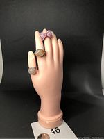 Full hand display showing all three rings worn on adjacent fingers, with clear visibility of stone types and ring designs.