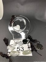 Seven Burma jade jewelry pieces displayed, including pendants and earrings with ropes and hooks.
