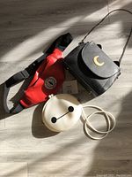 Overview of three bags placed on floor: red Spider-Man belt bag, black Sailor Moon black cat crossbody bag, and white Baymax silicone crossbody bag.